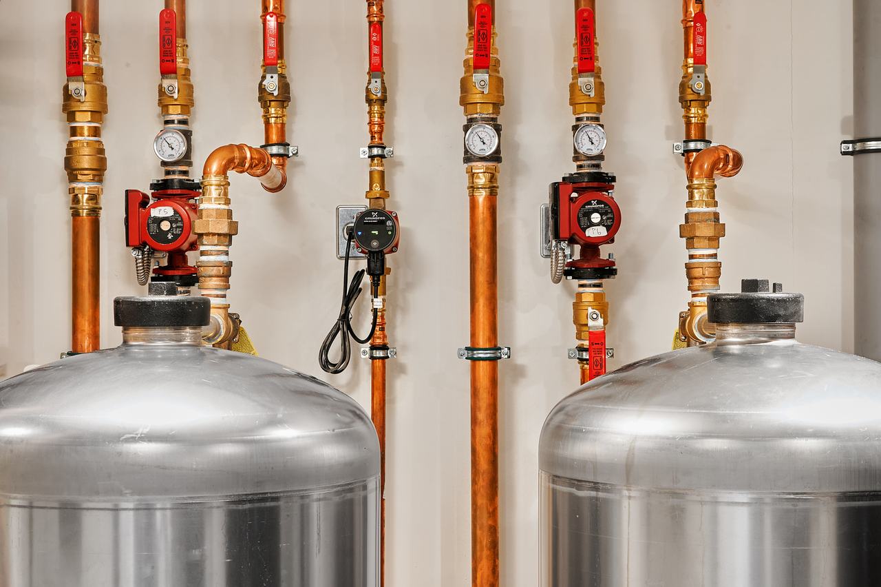 Stainless hot water storage tanks and circulator pumps in a Qualicum Beach home