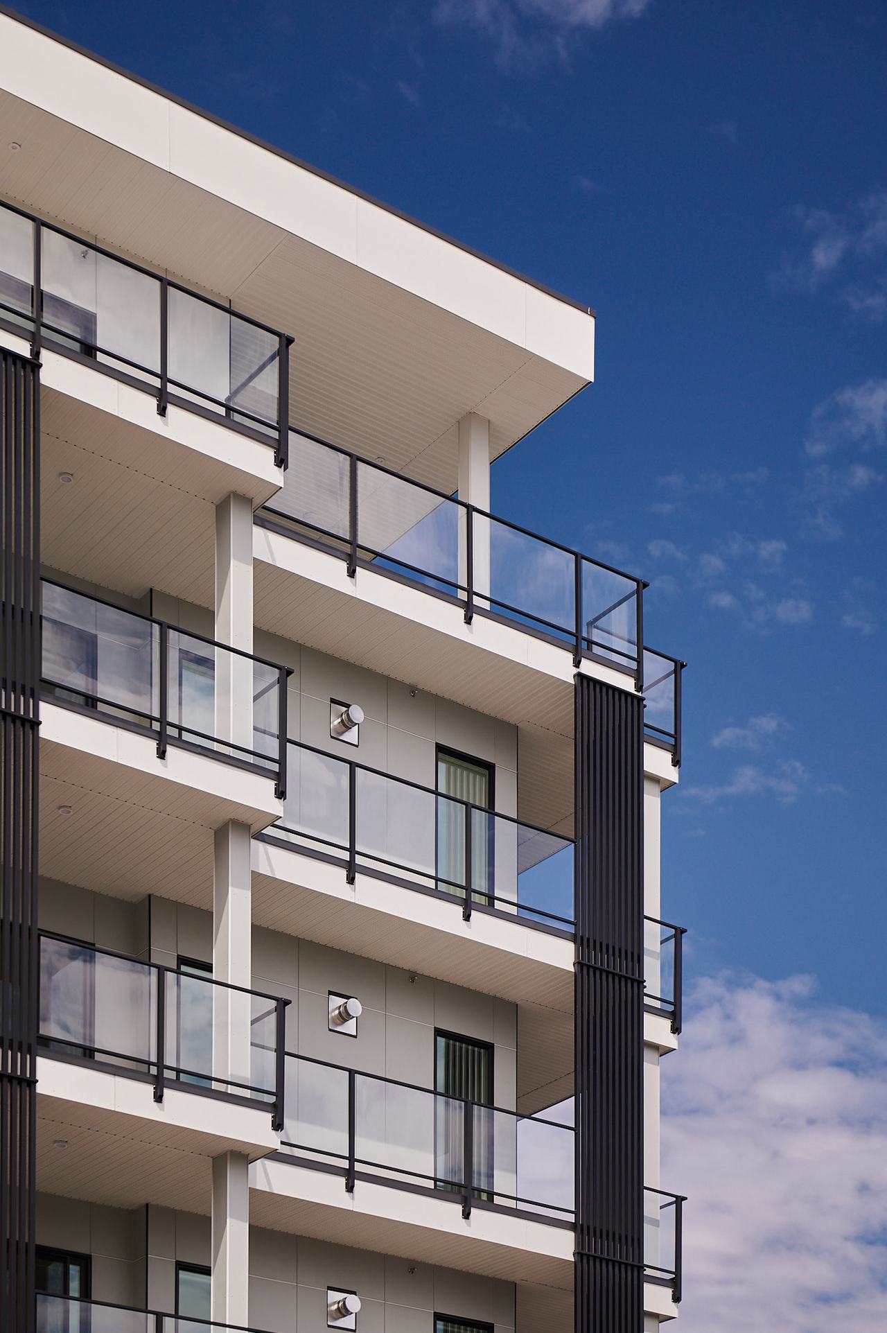 East Village residential building in Qualicum Beach against a blue sky