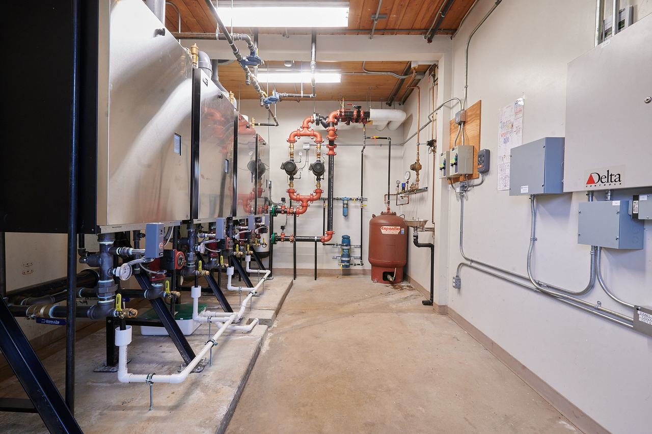 Commercial boiler room with new hydronic piping and controls at 2050 Latimer Road