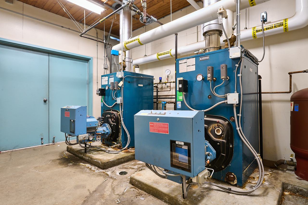 Original commercial boilers and flue piping before a Waywest boiler upgrade