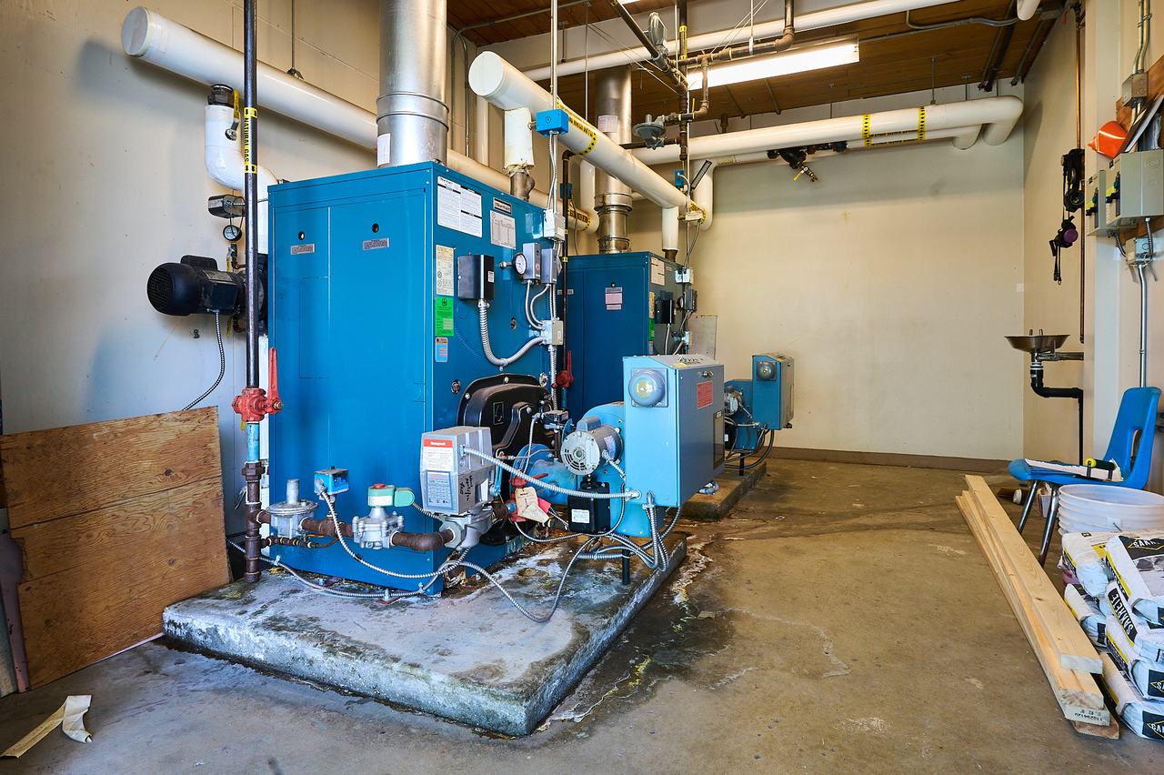 Aging commercial boilers in the Latimer Road mechanical room before replacement