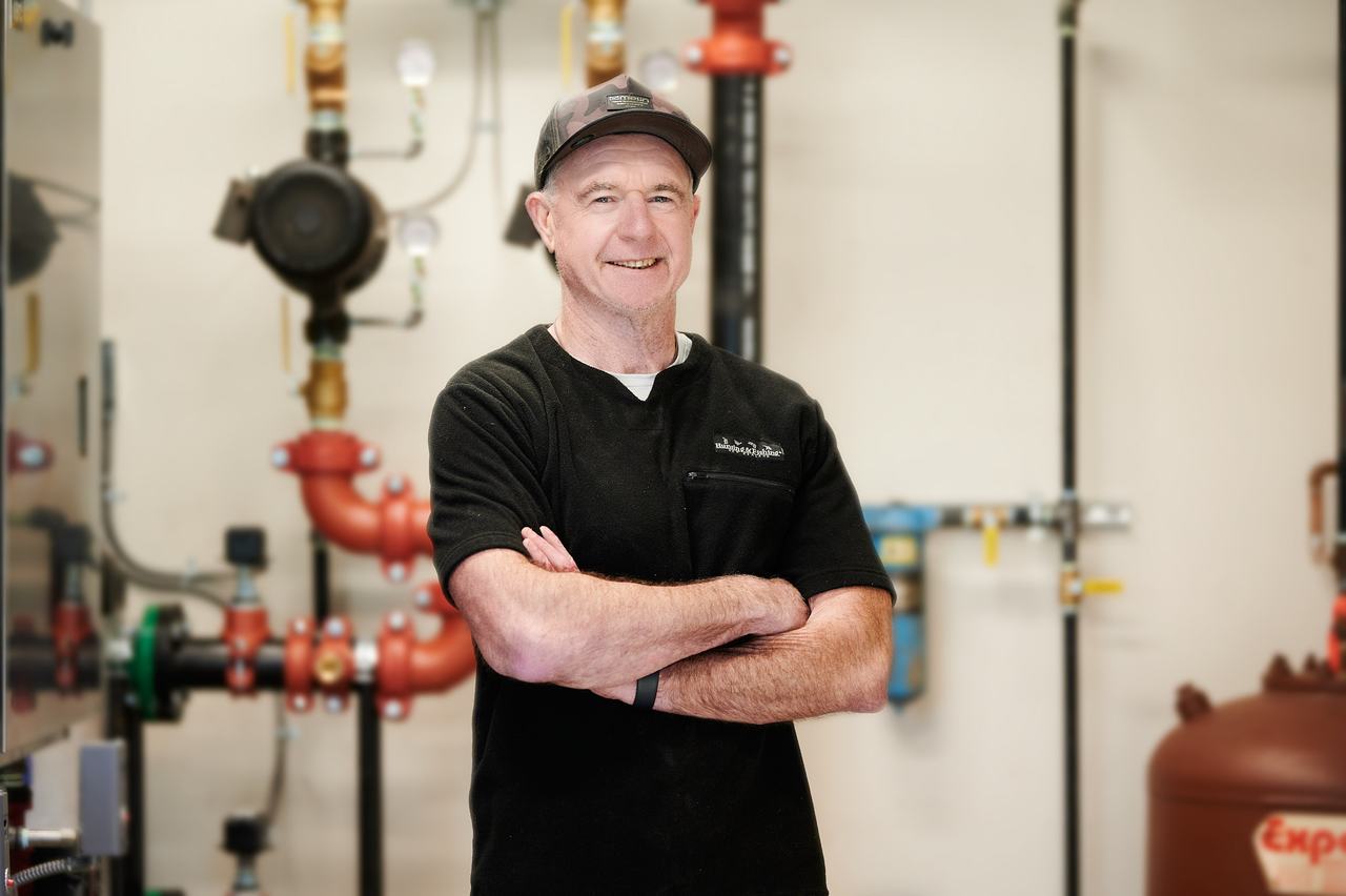 Matt Norman, founder and owner of Waywest Mechanical, in a completed commercial boiler room in Nanaimo