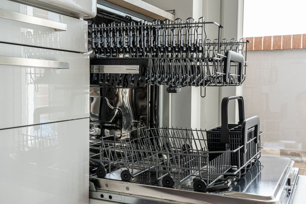 Open dishwasher with empty racks