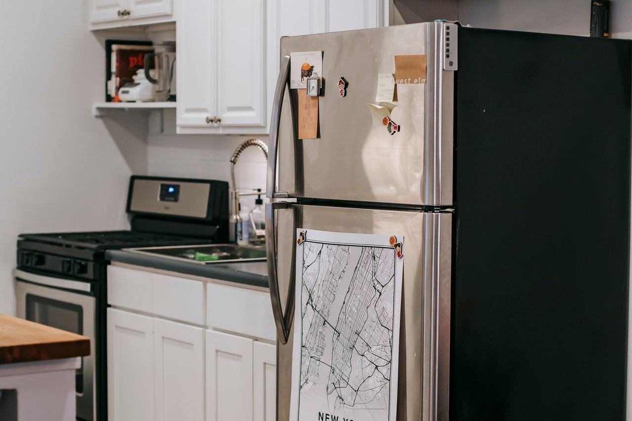 Kitchen with a refrigerator, range and white cabinets