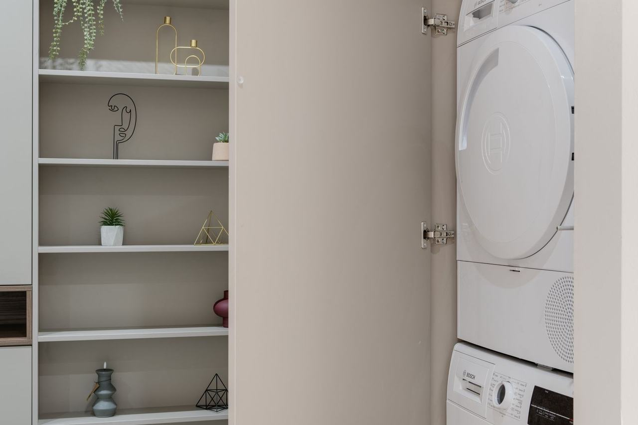 Stacked washer and dryer in a laundry cabinet