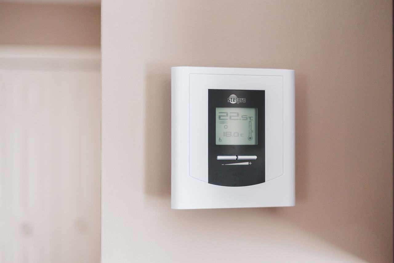 Digital thermostat mounted on a wall