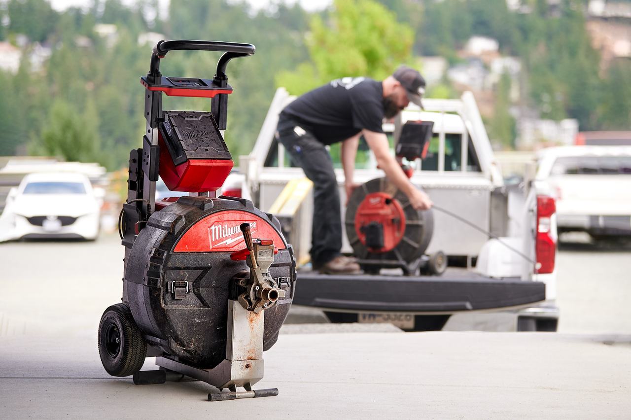 Drain cleaning machine and Waywest plumber at a service truck
