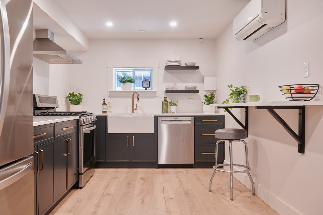 Ductless mini-split heat pump head installed above the kitchen in a Nanaimo suite