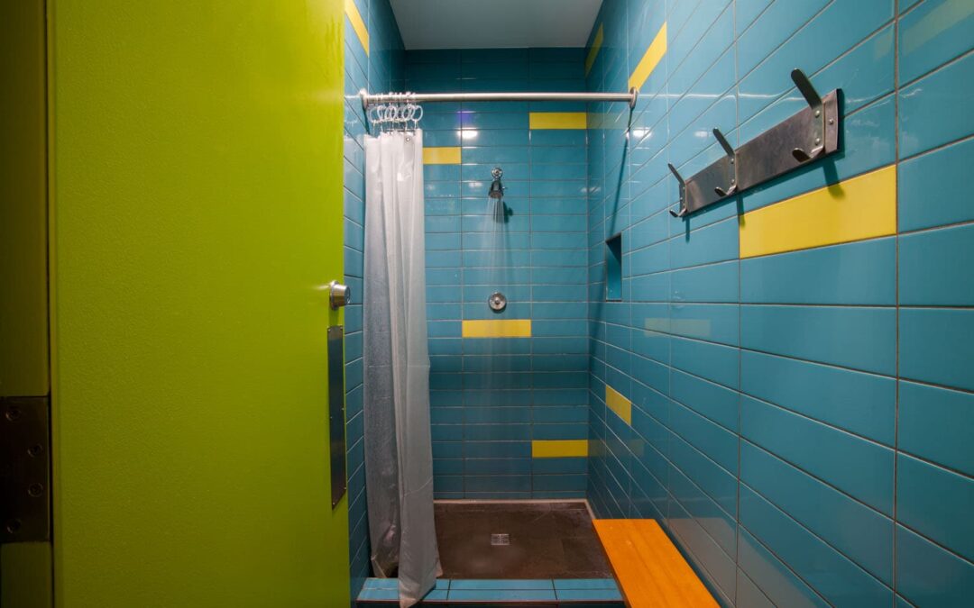 shower area with blue and yellow tiles